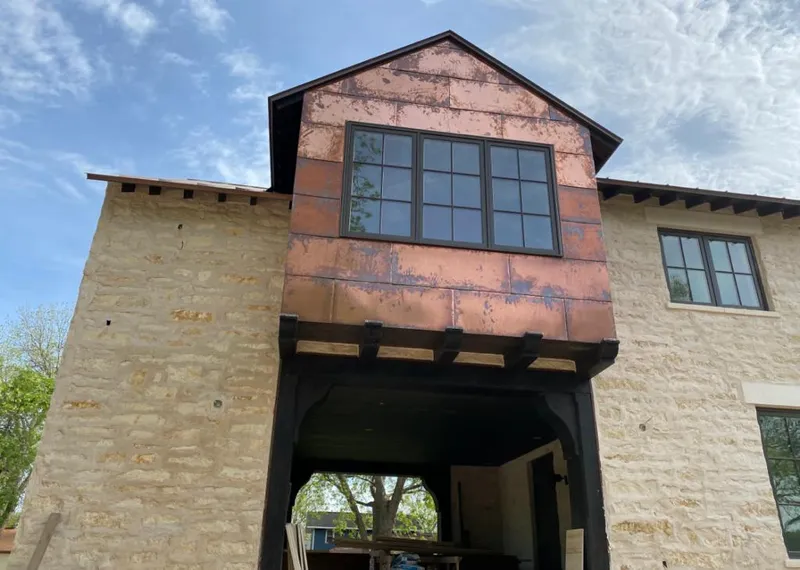 Copper metal panel facade on a stone building for Roof Repair in Mountain Park